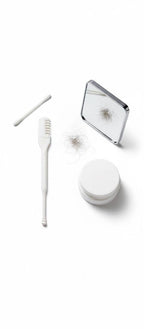 Set of dental care products including a toothbrush, container, and mirror on a white background