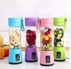 Four colorful portable blenders with fruits inside on a white background