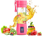 Pink portable blender with fruits inside on a white background