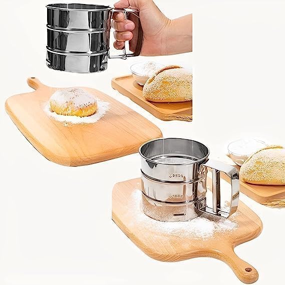 Metal flour sifter being used to dust powdered sugar onto pastries on a wooden board.