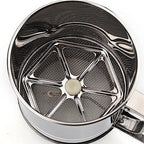 Metallic tea infuser with a central ball on a white background